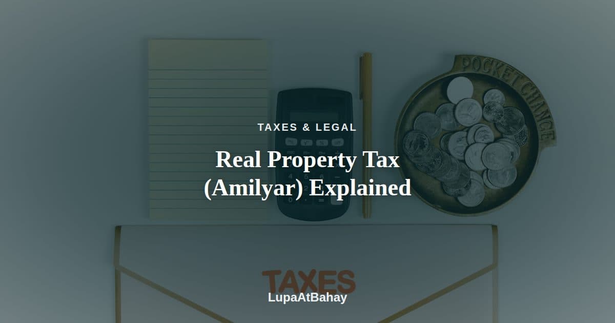 A calculator, notepad, dish of coins and a folder labeled “Taxes” laid out flat, under the headline “Real Property Tax (Amilyar) Explained”.